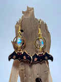 Gold bat and moon dangle earrings with glass bead accent