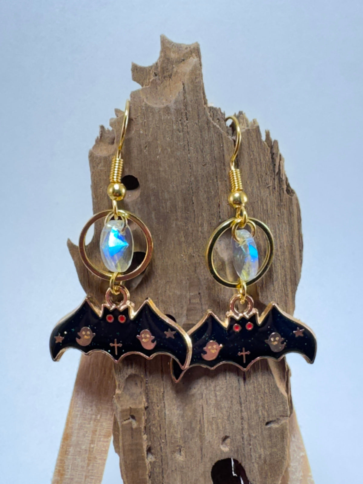 Gold bat and moon dangle earrings with glass bead accent