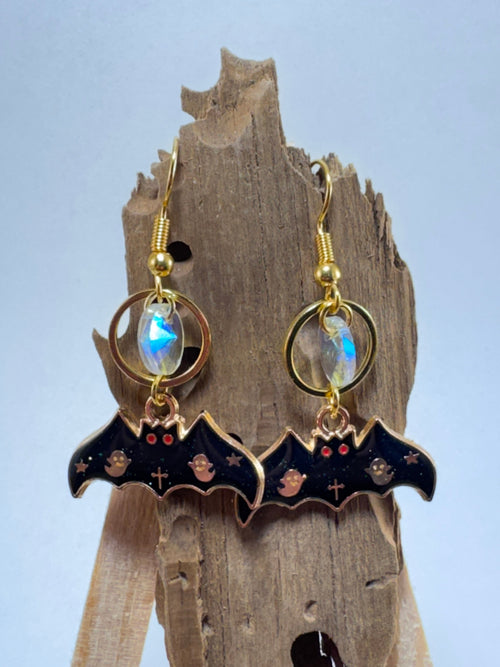 Gold bat and moon dangle earrings with glass bead accent