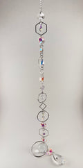 Iridescent white beaded sun catcher with Tree of Life charm, hexagon, oval, diamond, and circle silver frames, and clear teardrop pendant